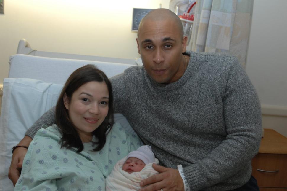 Danny Torres (right) and his wife Yashira Guzman with their baby girl.